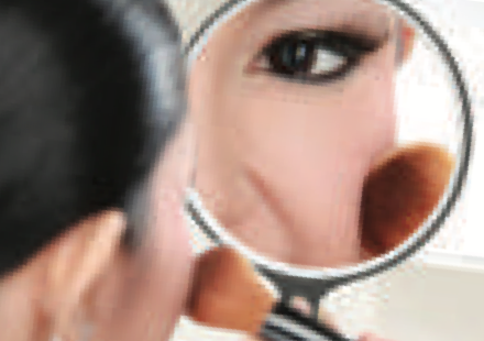 Mirror Q: a round hand mirror showing a magnified face